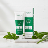 AOUFSE Skin Whitening Facial Cleanser green and white tube with box on marble surface